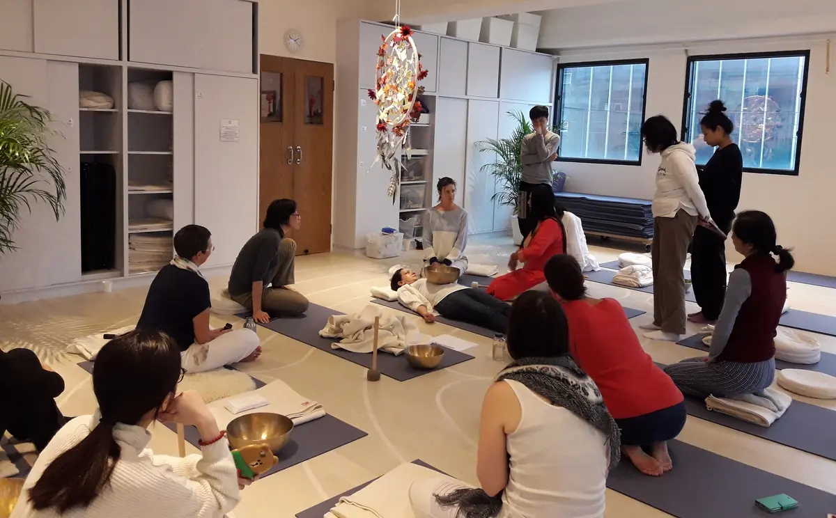 Participants learning with singing bowls at MAAYAA Healing School